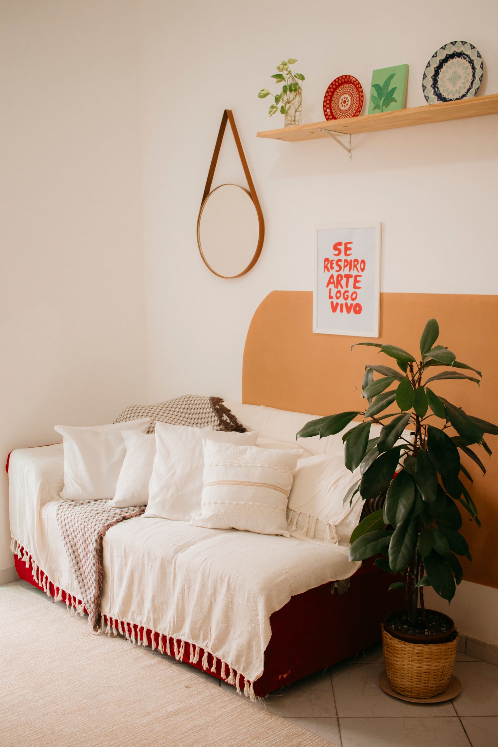 Bohemian style living room with rattan furniture, plants and macrame wall hanging